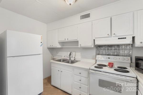 918 McAlway Road, Unit B Charlotte, NC 28211 - Photo 13 of 28 a kitchen with white cabinets and white appliances