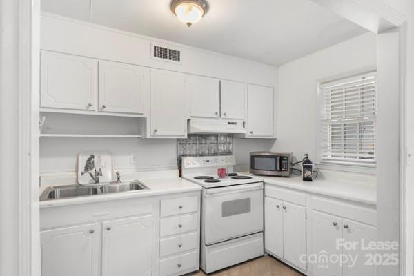 918 McAlway Road, Unit B Charlotte, NC 28211 - Photo 14 of 28 a kitchen with cabinets appliances a sink and a window