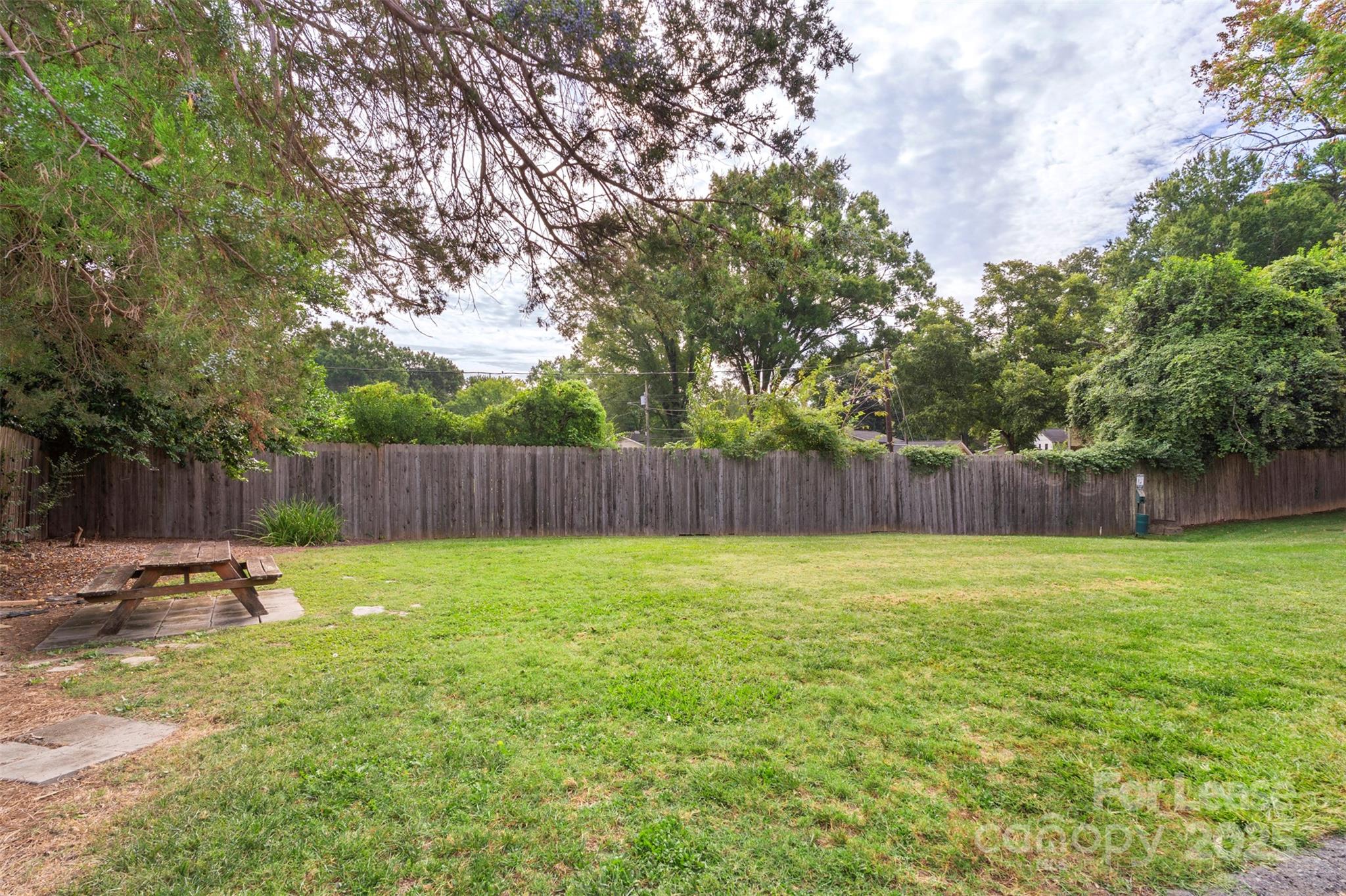 918 McAlway Road, Unit B Charlotte, NC 28211 - Photo 25 of 28 a view of a backyard with a slide and trees