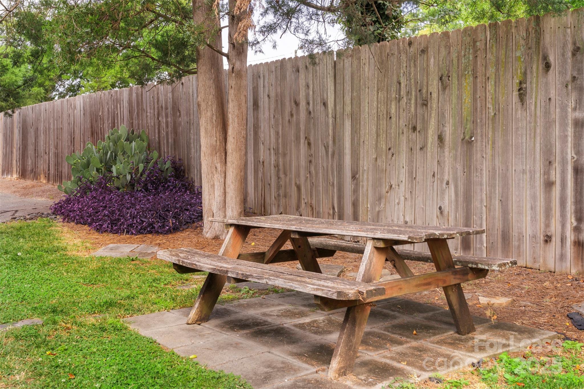 918 McAlway Road, Unit B Charlotte, NC 28211 - Photo 27 of 28 a bench sitting in middle of a yard