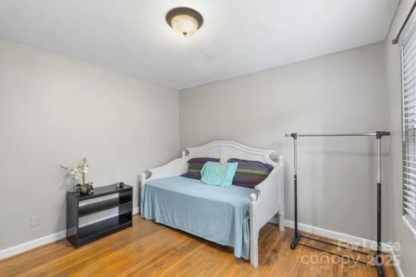 a bedroom with a bed and a mirror