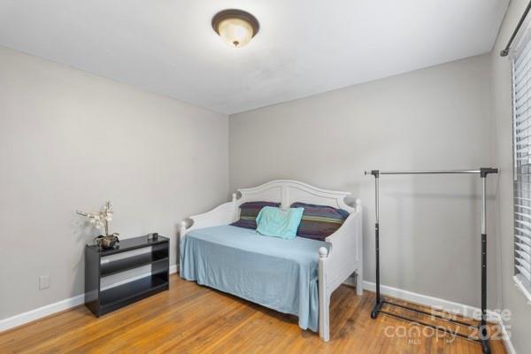 918 McAlway Road, Unit B Charlotte, NC 28211 - Photo 8 of 19 a bedroom with a bed and a mirror