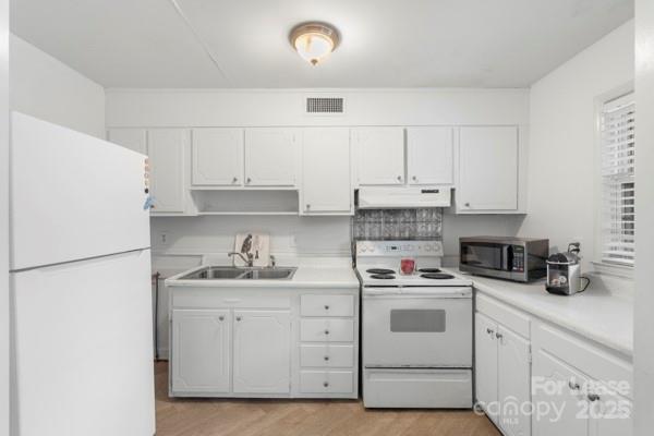 918 McAlway Road, Unit B Charlotte, NC 28211 - Photo 10 of 19 a kitchen with white cabinets and white appliances