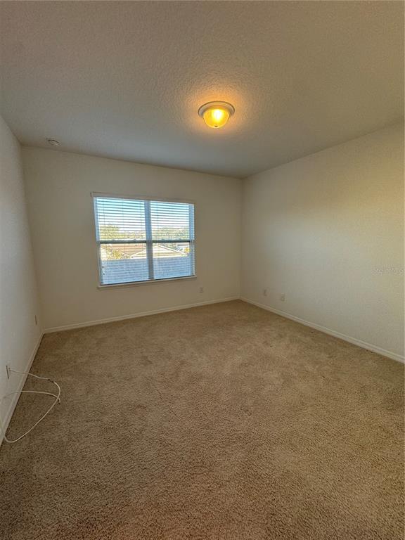 7708 Bexton Lane Windermere, FL 34786 - Photo 8 of 11 an empty room with a window
