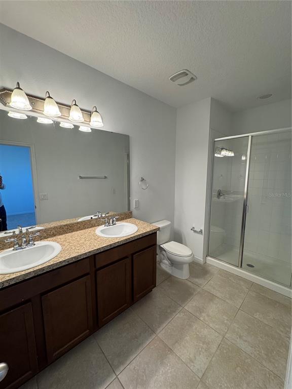 7708 Bexton Lane Windermere, FL 34786 - Photo 9 of 11 a bathroom with a double vanity sink toilet and shower