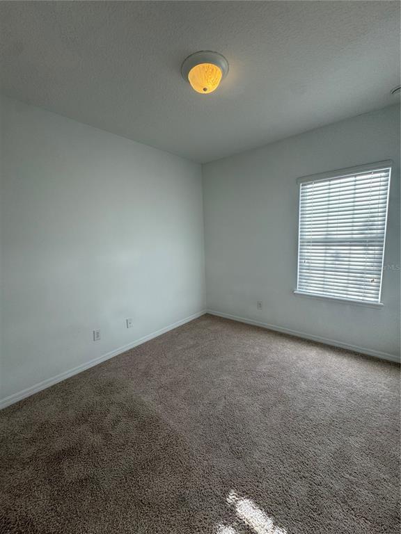 7708 Bexton Lane Windermere, FL 34786 - Photo 10 of 11 an empty room with a window