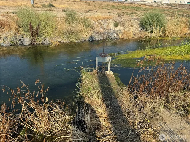 a view of a patio with table and chairs with wooden fence