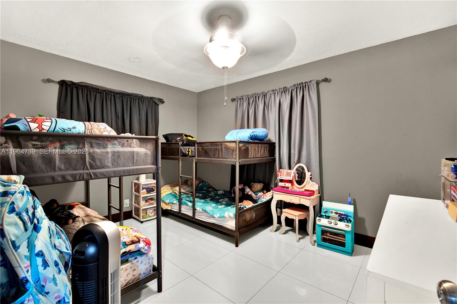 2771 Northwest 8th Street Pompano Beach, FL 33069 - Photo 14 of 27 a bedroom with furniture and a lamp