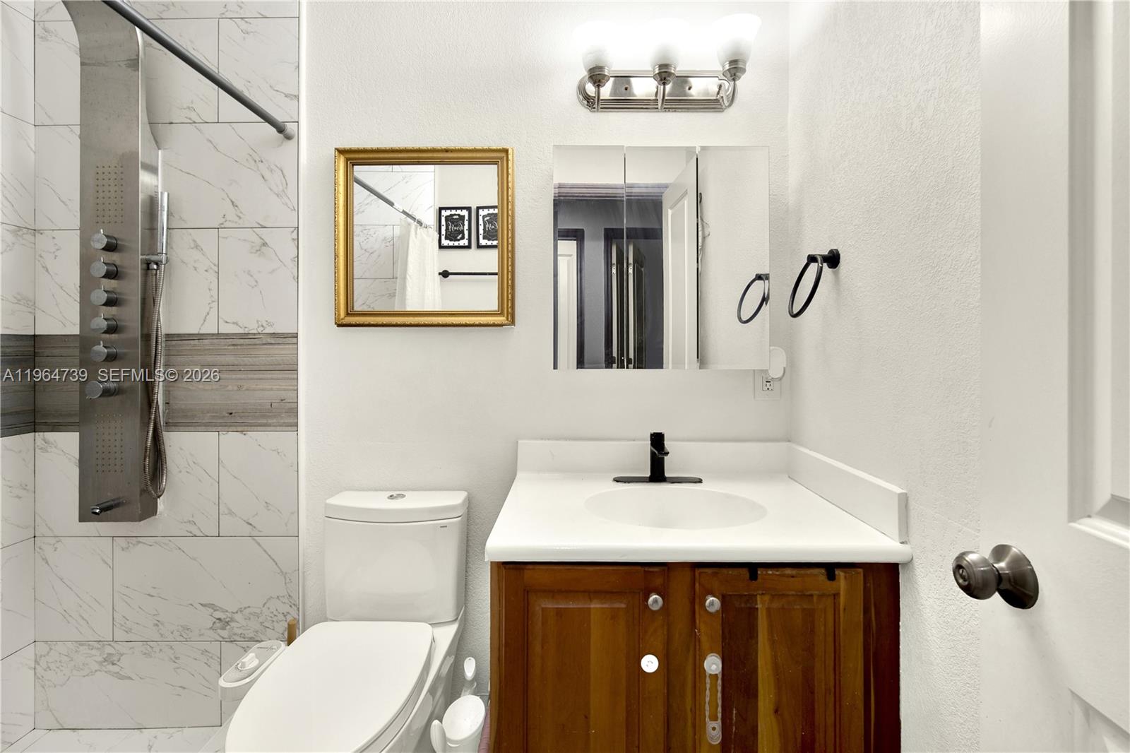 2771 Northwest 8th Street Pompano Beach, FL 33069 - Photo 16 of 27 a bathroom with a sink mirror vanity and toilet