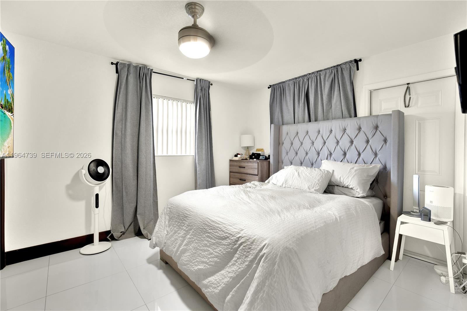 2771 Northwest 8th Street Pompano Beach, FL 33069 - Photo 17 of 27 a bedroom with a large bed and a window