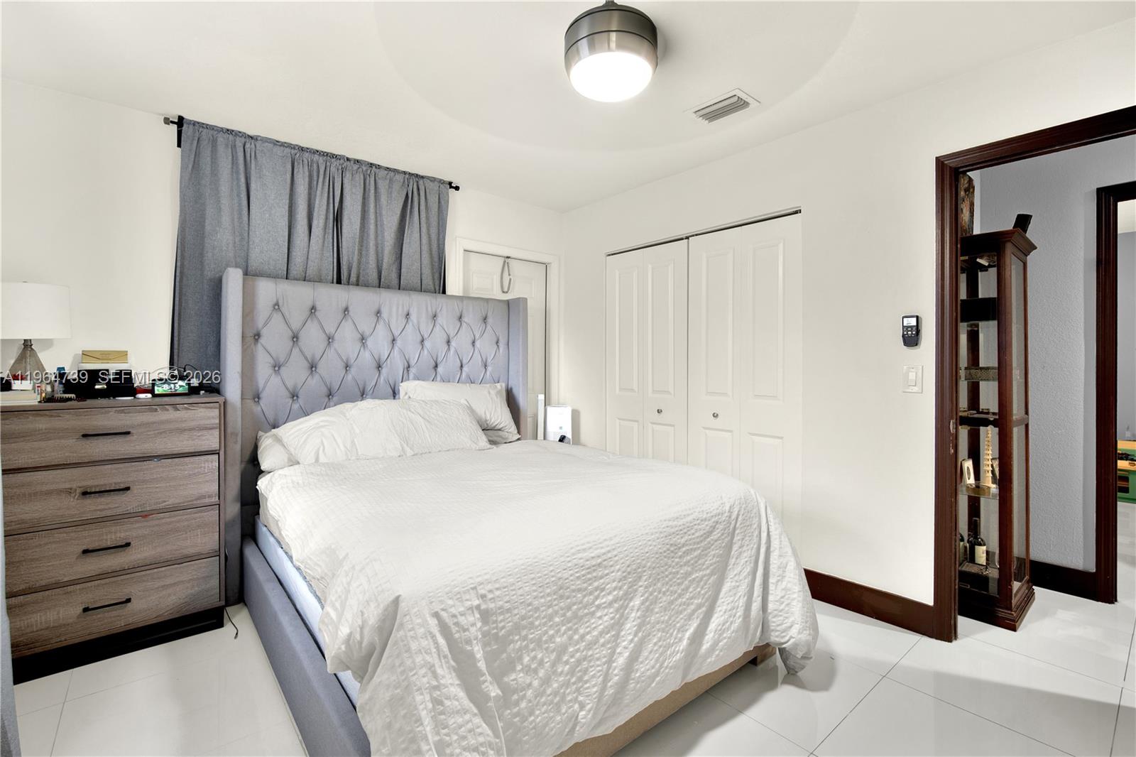 2771 Northwest 8th Street Pompano Beach, FL 33069 - Photo 18 of 27 a bedroom with a bed and a night stand