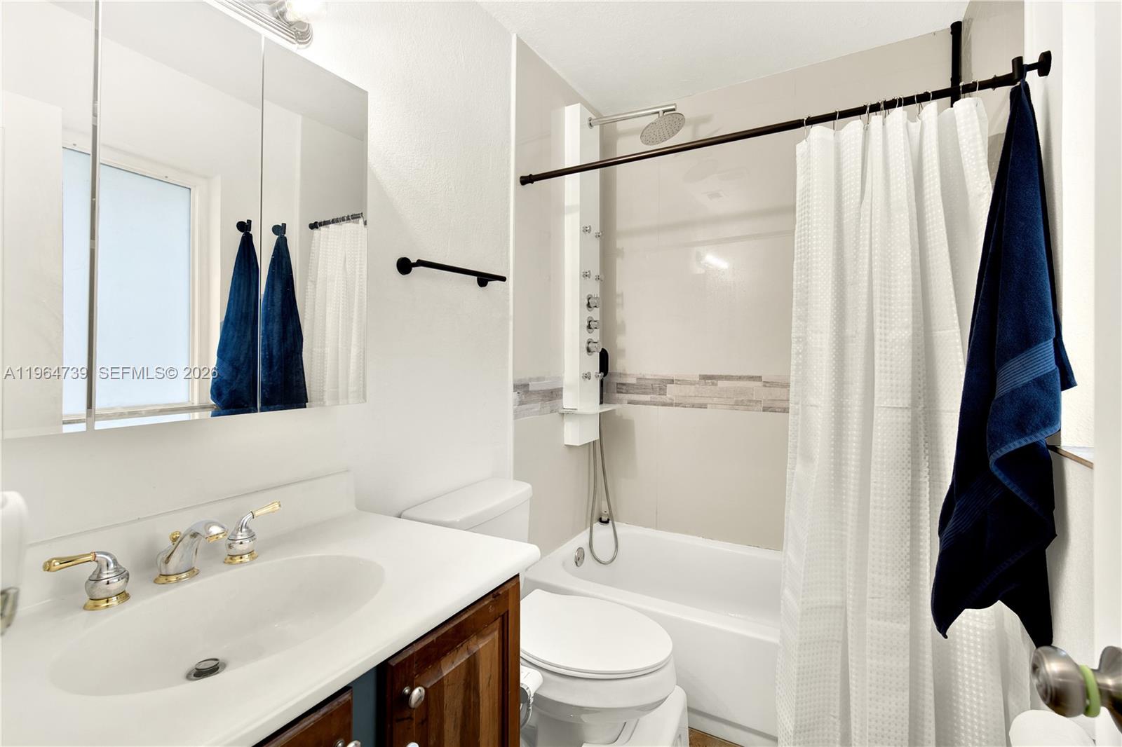 2771 Northwest 8th Street Pompano Beach, FL 33069 - Photo 19 of 27 a bathroom with a sink toilet and shower