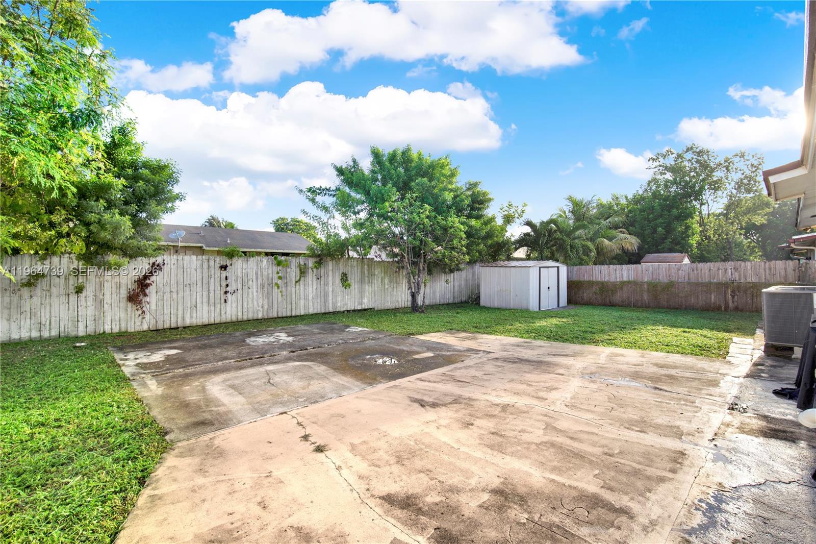 2771 Northwest 8th Street Pompano Beach, FL 33069 - Photo 20 of 27 a view of a yard with plants and trees