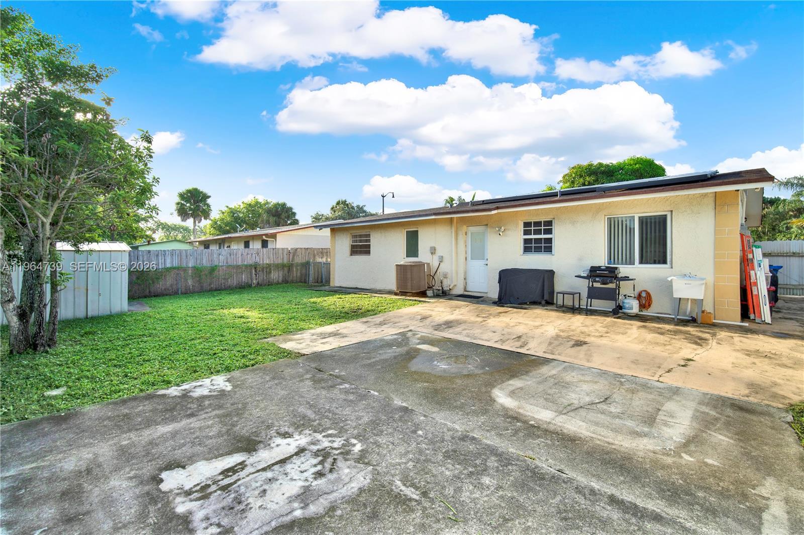 2771 Northwest 8th Street Pompano Beach, FL 33069 - Photo 21 of 27 a view of a house with backyard and a tree