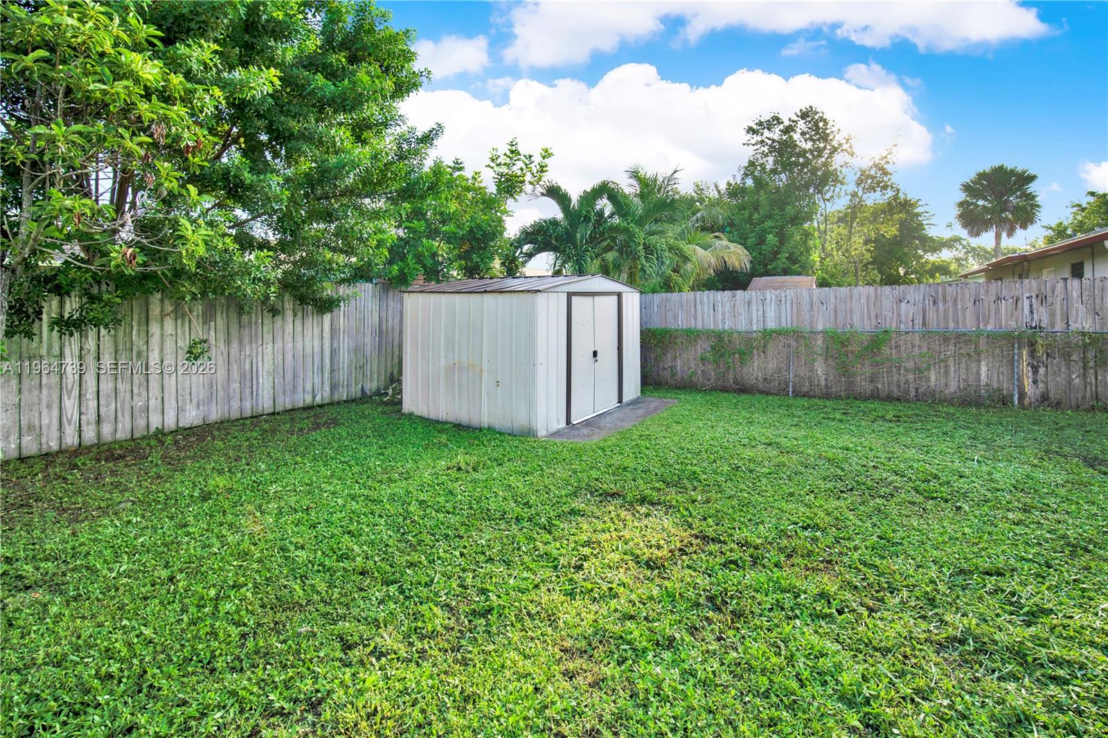2771 Northwest 8th Street Pompano Beach, FL 33069 - Photo 22 of 27 a view of a backyard with a plants and trees