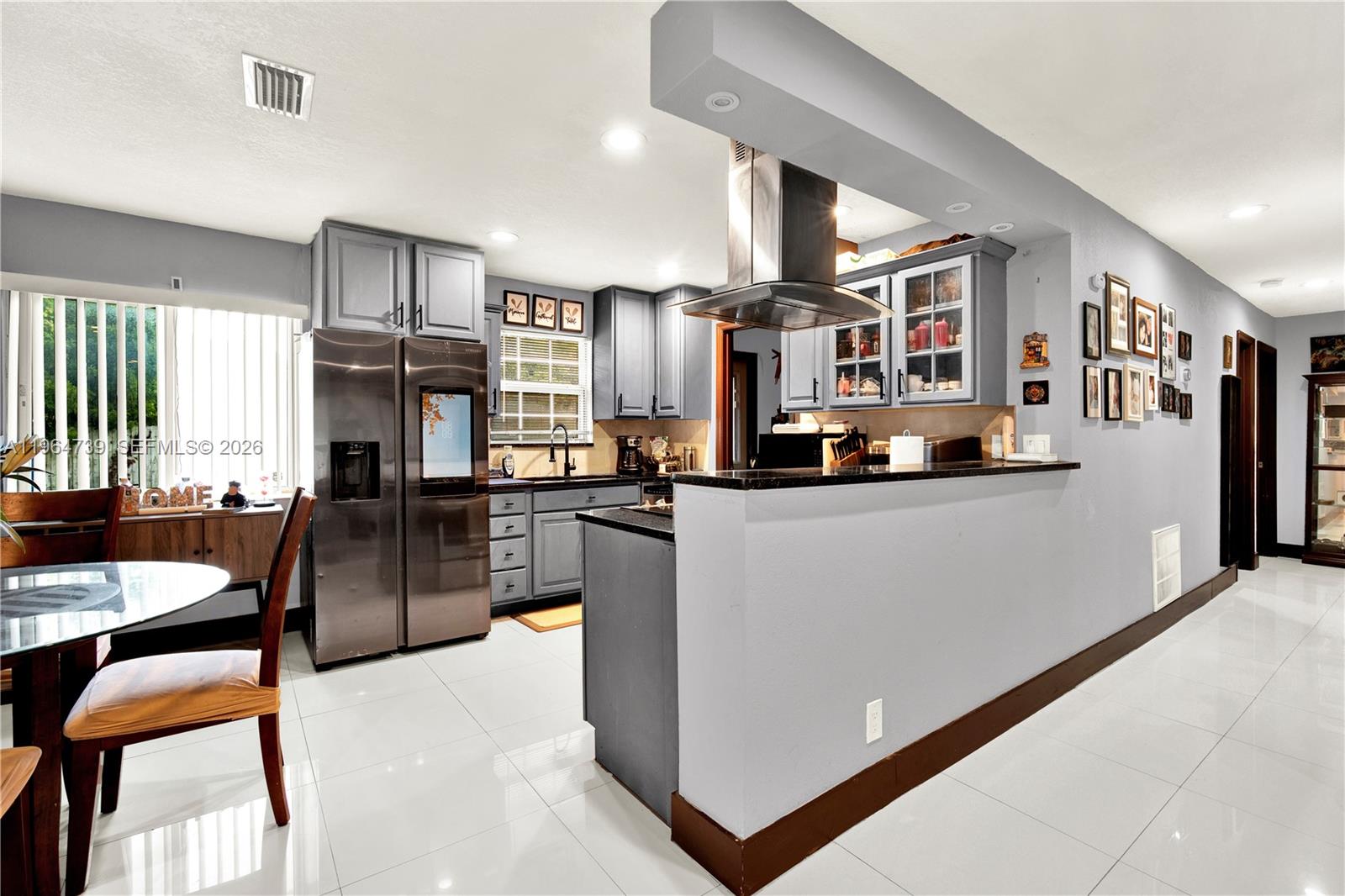 2771 Northwest 8th Street Pompano Beach, FL 33069 - Photo 5 of 27 a living room with stainless steel appliances kitchen island granite countertop furniture and a kitchen view