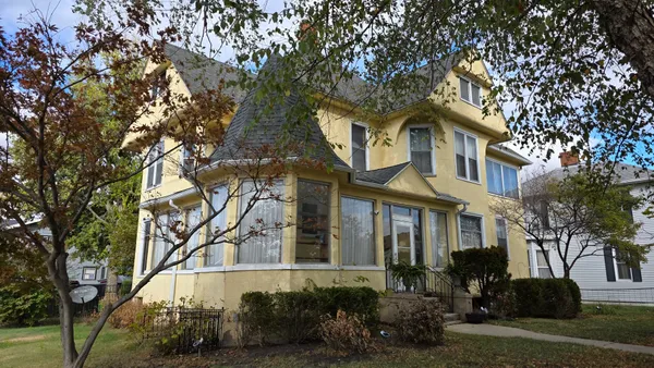 a front view of a house with a garden
