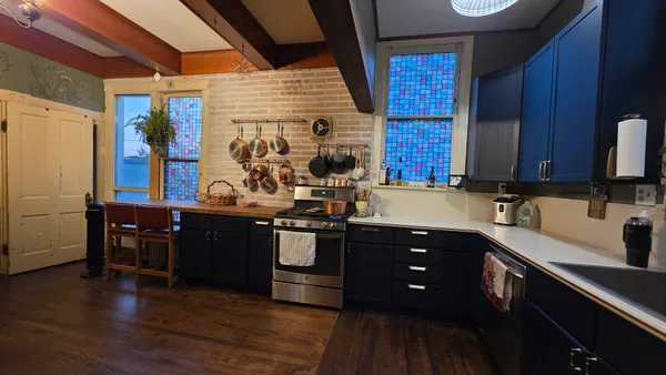 a kitchen with stainless steel appliances granite countertop a sink and wooden cabinets