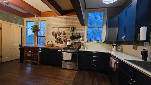 a kitchen with stainless steel appliances granite countertop a sink and wooden cabinets