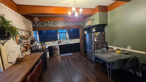 a kitchen with stainless steel appliances granite countertop a stove refrigerator and a wooden cabinets