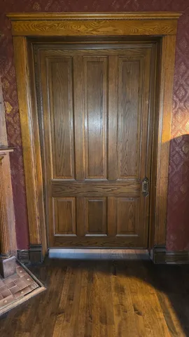 a bathroom with a toilet a sink a mirror and a window