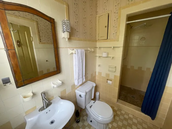 a spacious bedroom with a bed and large windows