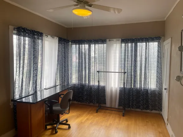 a bedroom with a bed and a dresser with mirror