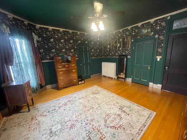 a view of an empty room with a fireplace and a window