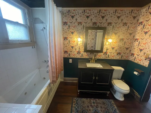 a view of a room with furniture and wooden floor