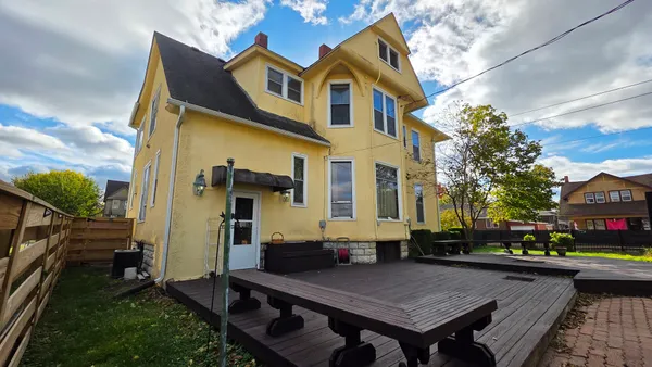 a aerial view of a house with table and chairs