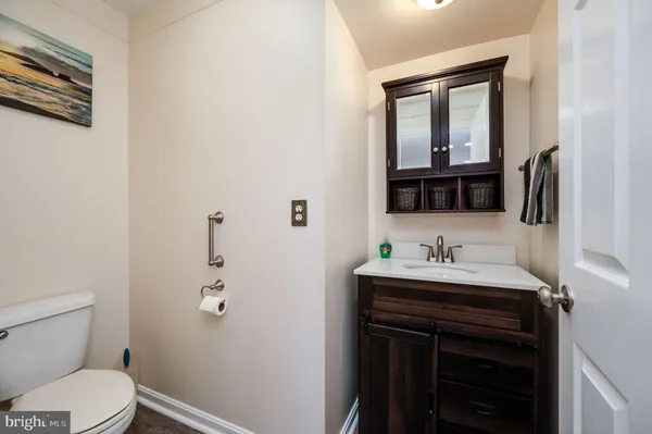 a bathroom with a toilet sink and mirror