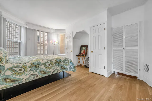 a spacious bedroom with a bed and a dresser