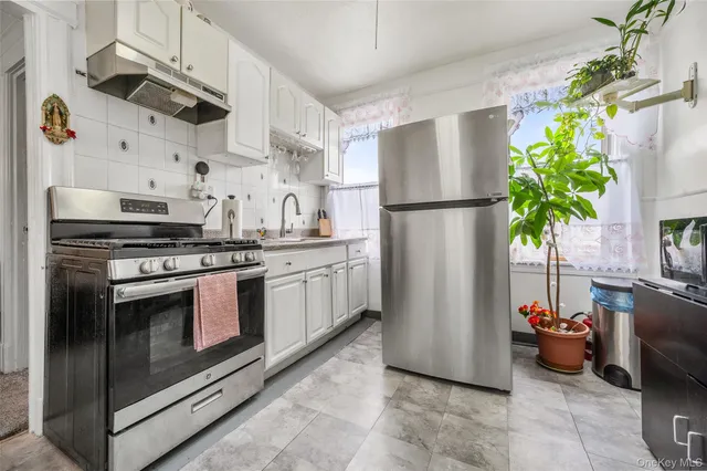 a kitchen with stainless steel appliances a refrigerator sink and stove