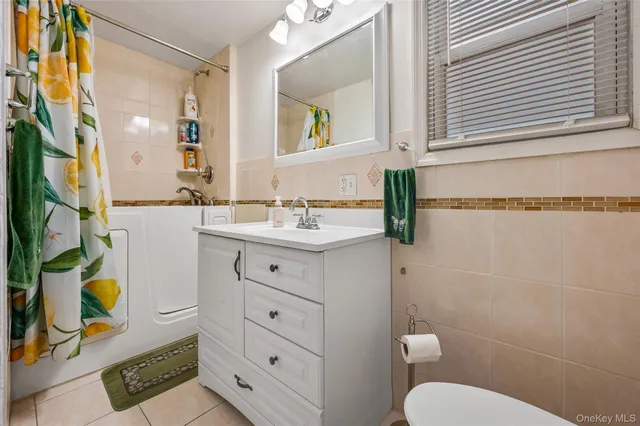 a bathroom with a sink mirror vanity and toilet
