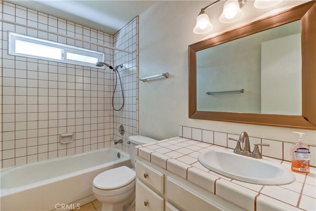 a view of an empty room with closet and wooden floor