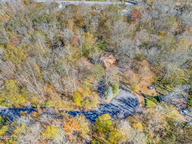 a view of a livingroom with wooden floor and a ceiling fan