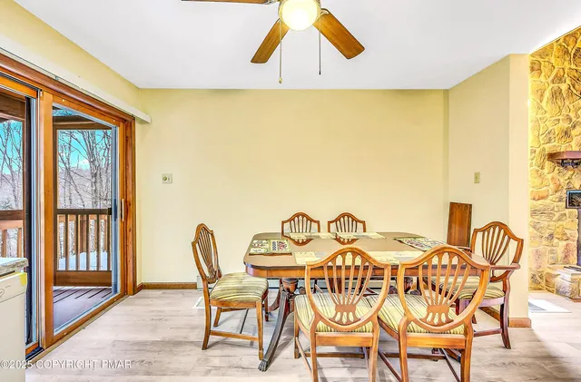 a view of a bedroom with a ceiling fan and window