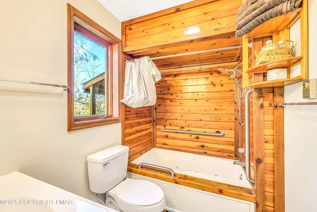 a view of a kitchen with stainless steel appliances wooden floor and a large window