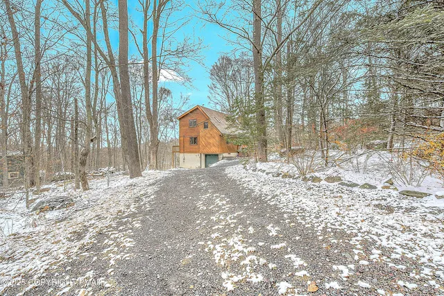 a view of a house with snow on the background