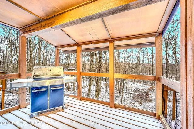a view of a wooden fence with trees in the background