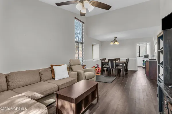 a living room with furniture and wooden floor