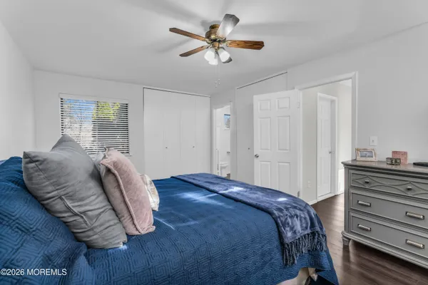 a bed sitting in a bedroom next to a window and a chandelier