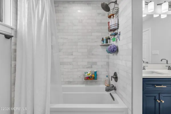 a bathroom with a tub and shower