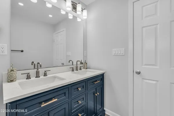 a bathroom with a sink double vanity and a mirror