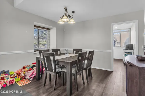 a view of a dining room with furniture and wooden floor