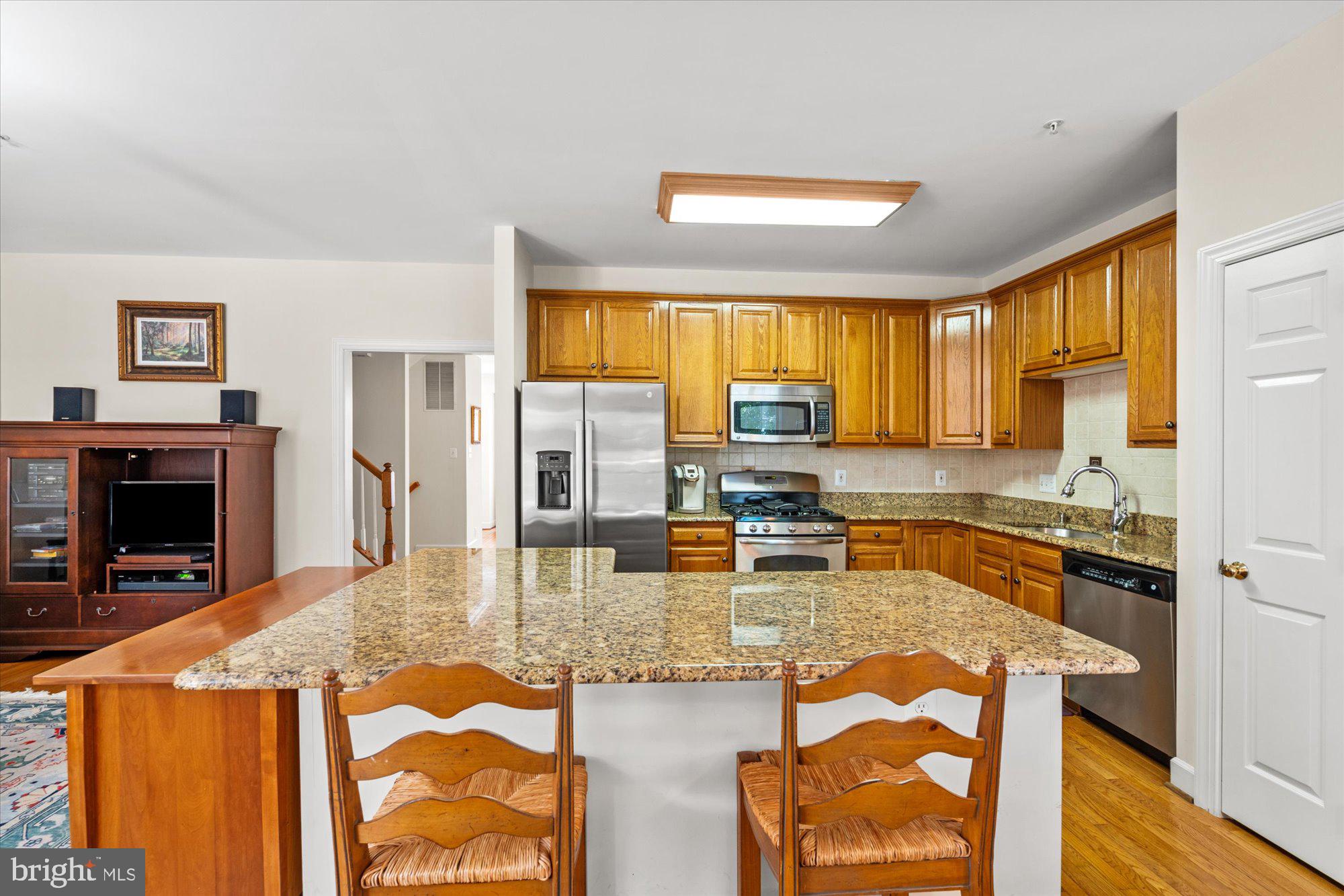 8510 Bells Ridge Terrace Potomac, MD 20854 - Photo 12 of 42 a kitchen with granite countertop a stove and a refrigerator