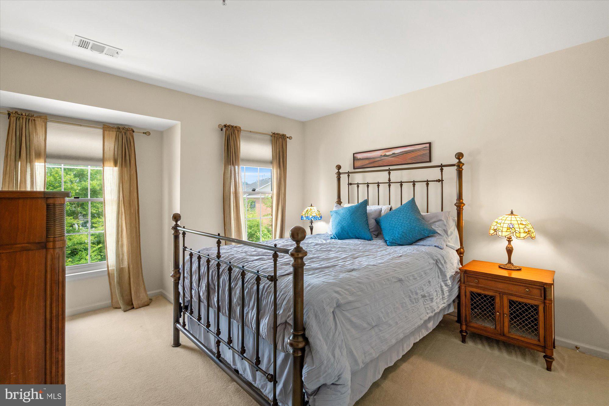 8510 Bells Ridge Terrace Potomac, MD 20854 - Photo 21 of 42 a bed sitting in a bedroom next to a window