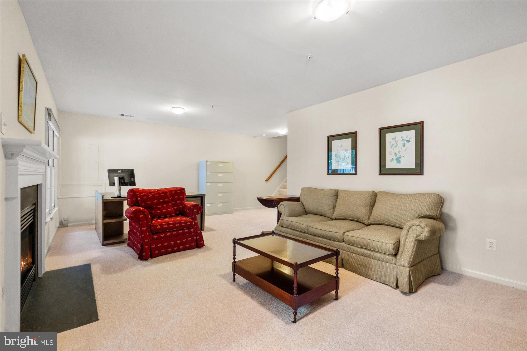 8510 Bells Ridge Terrace Potomac, MD 20854 - Photo 27 of 42 a living room with furniture and a fireplace
