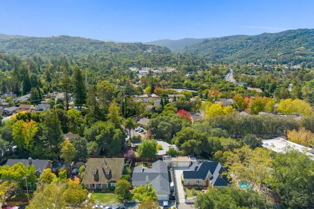 an aerial view of residential house with outdoor space and trees