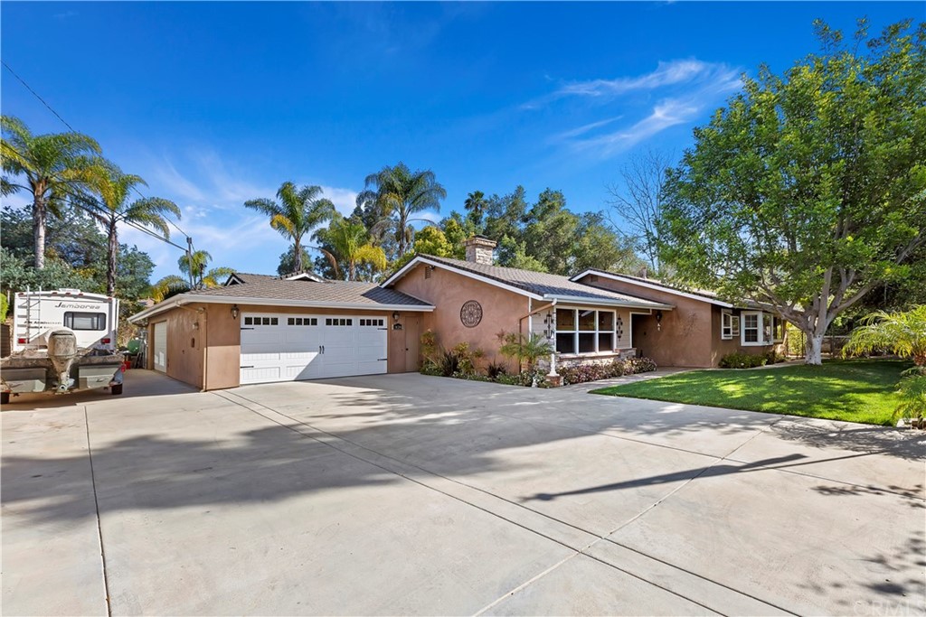 1424 East Mission Road Fallbrook, CA 92028 - Photo 1 of 1 a front view of a house with a yard and trees